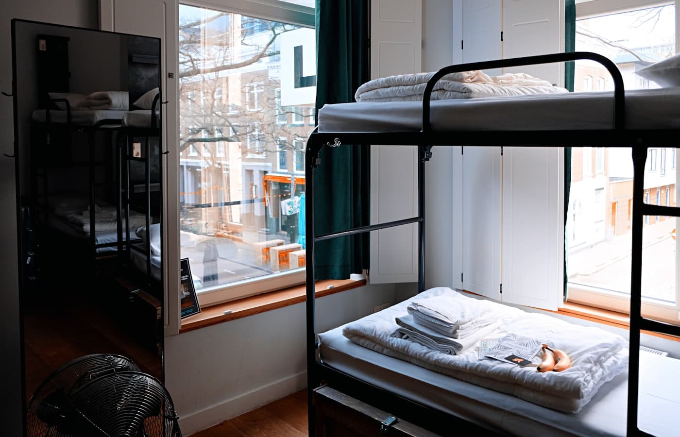 A freshly made hostel bunk room